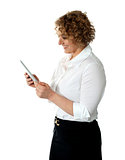 Smiling businesswoman looking at tablet pc