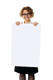 Curly haired woman holding advertising board
