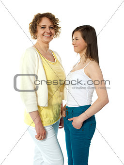 Pretty teenage girl looking at her modern mum
