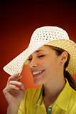 pretty woman with straw hat smiling and having fun