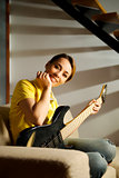 portrait of woman playing with electric guitar at home