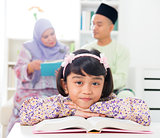 Muslim girl reading book.