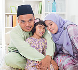 Muslim parents hugging child