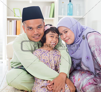 Muslim parents hugging child