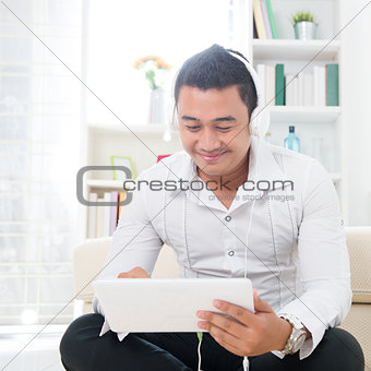 Asian man using tablet pc