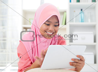 Asian teen using tablet pc computer. 