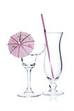 Cocktail glasses with drinking straw and umbrella