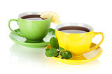 Two colorful cups of tea with lemon and mint