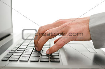Detail of business man hand using laptop