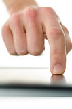 Detail of male hand working on touch screen device