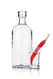 Bottle of vodka and shot glass with red chili pepper