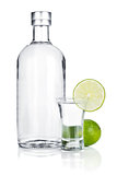 Bottle of vodka and shot glass with lime slice
