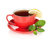 Red tea cup with lemon and mint