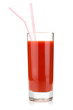 Tomato juice in glass with two drinking straws