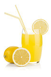 Lemon juice glass and fresh lemons