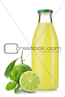 Lime juice bottle, ripe limes and mint