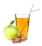 Apple juice in a glass, green apple and cinnamon sticks