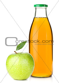 Apple juice in a glass bottle and ripe apple