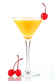 Alcohol cocktail with orange juice and three maraschino