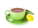 Green tea cup and yellow tulip
