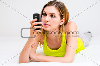 woman using cell phone in bed