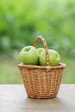 green apples in a wicker basket