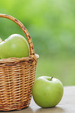 green apples in a wicker basket