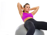 Fitness young woman doing abdominal crunch on fitness ball