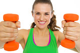 Smiling fitness young woman with dumbbells