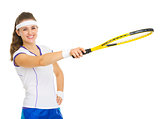 Happy tennis player pointing on copy space with racket
