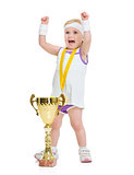 Happy baby in tennis clothes with medal and goblet rejoicing suc