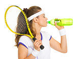 Female tennis player drinking water