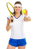 Portrait of smiling female tennis player with racket and ball