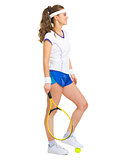 Happy female tennis player with racket and ball looking on copy 