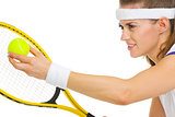 Closeup on female tennis player serving ball