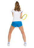 Female tennis player in stance . rear view
