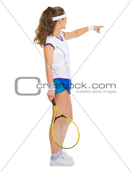 Female tennis player pointing on copy space