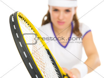 Closeup on racket in hand of tennis player in stance