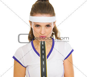 Confident tennis player holding racket