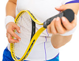 Closeup on female tennis player playing on racket as on guitar