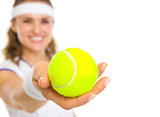 Closeup on female tennis player giving tennis ball