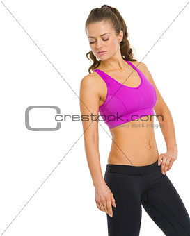 Fitness young woman looking down on copy space
