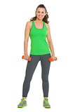 Full length portrait of happy fitness young woman with dumbbells