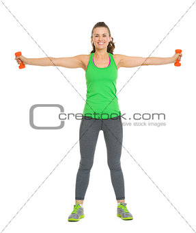 Full length portrait of smiling young woman workout with dumbbel