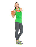 Full length portrait of smiling fitness young woman making exerc