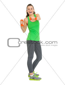 Full length portrait of smiling fitness young woman making exerc