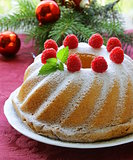 Christmas round sponge cake with raspberries
