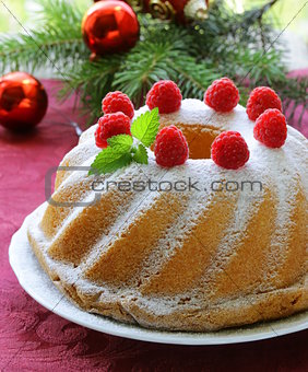 Christmas round sponge cake with raspberries