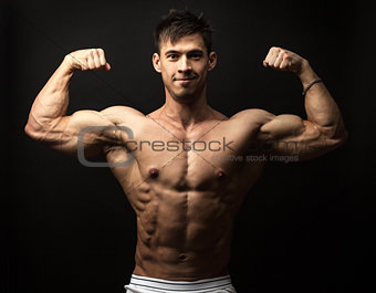 Portrait of muscular man flexing his biceps