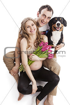 Pregnant couple and Entlebucher Sennenhund dog
